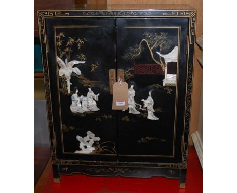 A contemporary Japanese black lacquered and mother of pearl inset double door low side cupboard, width 59cm