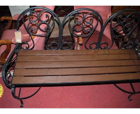 A black painted wrought iron and stained teak slatted three-seater garden bench, width 139cm