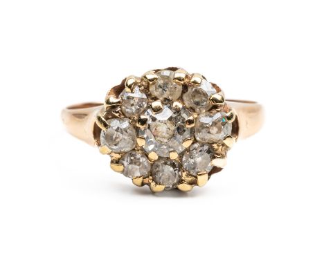 A GOLD AND DIAMOND NINE STONE CLUSTER RINGClaw set with the principle old cut cushion shaped diamond at the centre in a surro