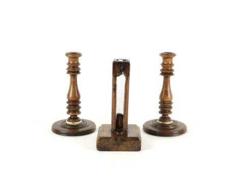 A PAIR OF TREEN CANDLESTICKS AND AN UNUSUAL OAK SQUARE SECTION EJECTOR CANDLESTICK (3)19th Century 
Of turned baluster form, 