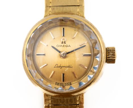 AN OMEGA LADYMATIC 18CT GOLD BRACELET WRISTWATCHThe signed brushed gilt dial with baton hour markers and with black hands, th