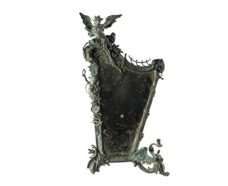 A NORTH EUROPEAN ‘BELLE EPOQUE’ BRONZE LYRE SHAPED DRESSING TABLE MIRRORCirca 1890/1900
The asymmetrical frame surmounted by 