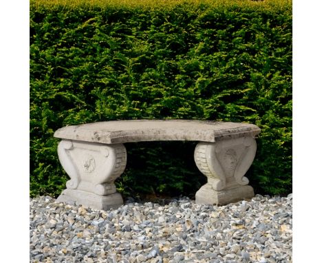 A RECONSTITUTED STONE CURVED GARDEN BENCH (3)105cm wide; 36cm high, together with a reconstituted stone stepped square base, 