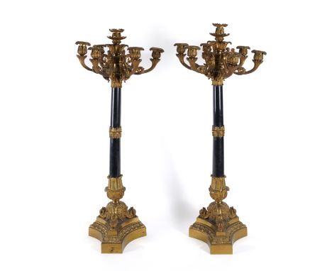 A PAIR OF FRENCH GILT-BRONZE AND BLACK MARBLE MOUNTED SEVEN-LIGHT CANDELABRA (2)Mid-19th Century 
Each with lotus leaf and ac