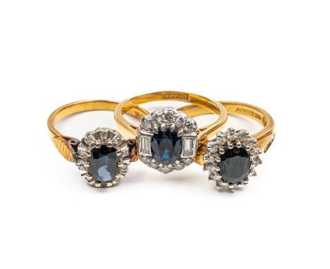 THREE 18CT SAPPHIRE AND DIAMOND CLUSTER RINGS (3)All mounted with oval cut sapphires and single cut diamonds, one with baguet