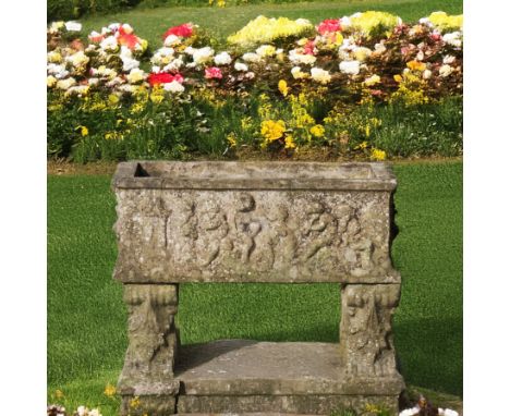 A RECTANGULAR RECONSTITUTED STONE PLANTERRelief cast with cherubs, on acanthus stone pedestals, 89cm wide; 40cm deep; 33cm hi