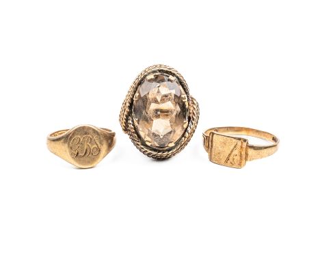 THREE 9CT GOLD RINGS (3)Comprising a smokey quartz ring, size K, and two signet rings, one size E½, the other size L, gross w
