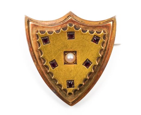 A VICTORIAN GOLD, HALF PEARL AND RUBY SHIELD SHAPED BROOCHMounted with a half pearl at the centre, in a surround of six cushi