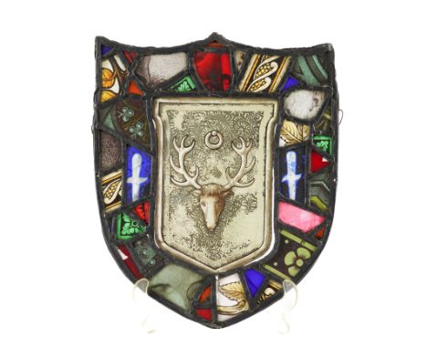 TWO STAINED AND LEADED GLASS HERALDIC STYLE PANELS (2)Incorporating 19th century and earlier elements
The first of shield sha