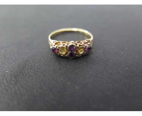 A pretty Victorian style yellow gold amethyst and citrine ring set with four amethysts and two citrines in a collett and claw