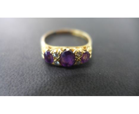 An 18ct gold amethyst and diamond ring size R - signs of re sizing, stones bright - total weight approx 4.5 grams
