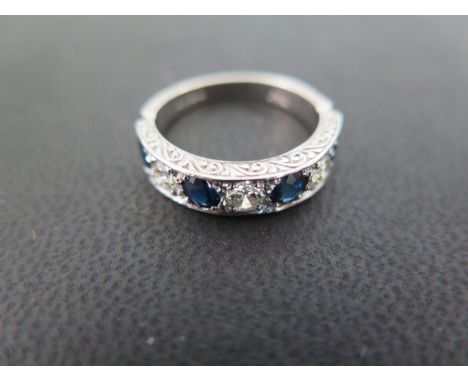 An 18ct white gold sapphire and diamond ring set with four sapphires and three brilliant cut diamonds each approx 0.25ct - ri