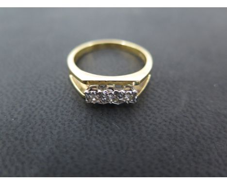 An 18ct gold three stone diamond ring with deceptive setting ring size S - approx weight 5 grams