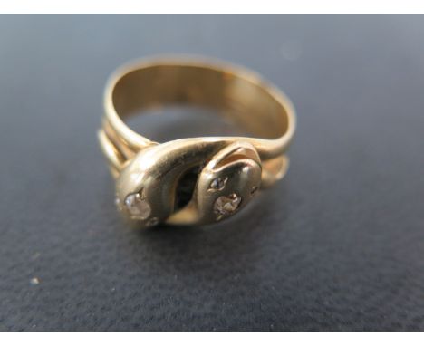 An 18ct yellow gold and diamond ring in the form of entwined snakes - approx 8.2 grams - size T