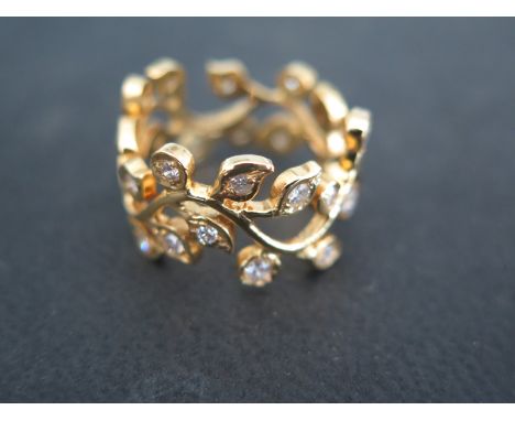 An 18ct yellow gold and diamond ring - total diamond weight approx 1.7ct set in a flowing leaf setting - 27 small diamonds se