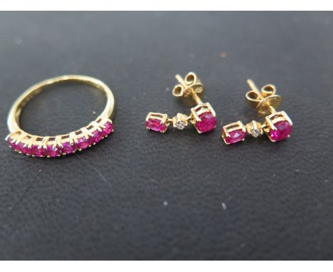 An 18ct gold and ruby ring set with 8 rubies and a pair of ruby and diamond drop earrings set with two rubies and a diamond t