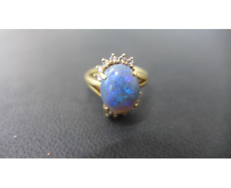 An 18ct gold opal and diamond ring size K - opal approx 12mm x 9mm - total weight approx 6 grams - minor wear