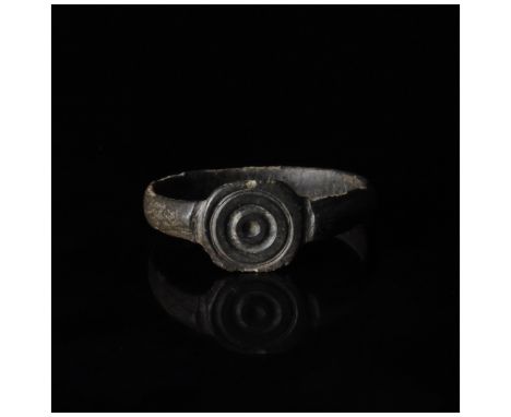 1-300 AD, Roman. Ring with circular loop, and raised round bezel bearing an incised decoration comprising numerous incised ci