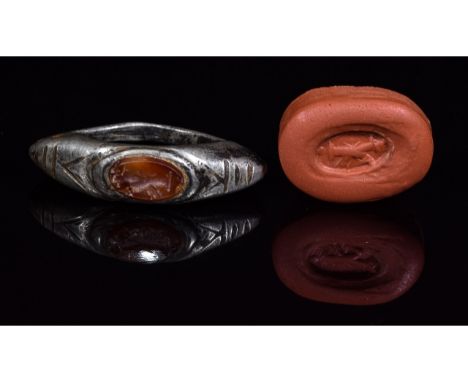 1-300 AD, Roman. Hexagonal silver ring with etched decoration on the shoudler and an oval-shaped carneilian intaglio with 'de