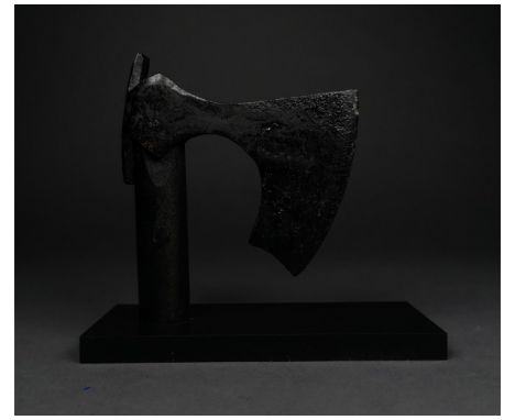 c. 900-1100 AD. Viking Age. An iron bearded axe head with a heavy curved blade, a round socket and rectangular flanges. The i