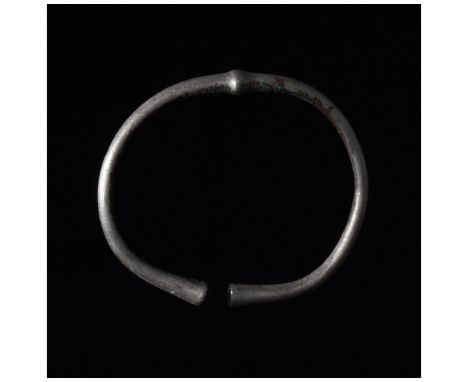C. 700-900 AD, Viking Age. A fine silver bracelet with a solid lentoid-shaped central decoration, circular section and gently