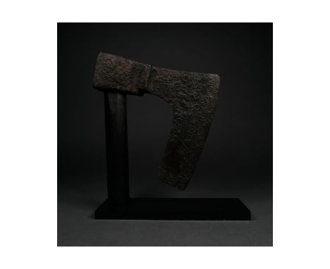 c. 900-1100 AD. Viking age. An iron bearded axe head with an elongated, heavy blade and a round socket. One side of the blade