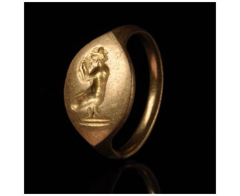 c. 350-100 BC. Ancient Hellenistic. A heavy gold ring with a D-shaped band and an almond-shaped bezel bearing an incised imag