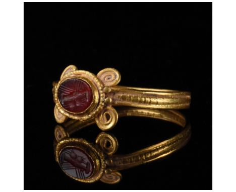 1-300 AD, Roman. Gold ring with a circular hoop, coiled decoration on the shoulders and an oval-shaped intaglio with 'dextrar