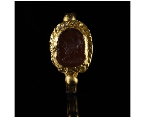 Ca.100 AD, Roman. Well-preserved gold intaglio ring comprising circular hoop with incised decoration and applied spherical ba