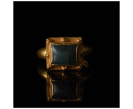 C. 1300-1400 AD, Medieval British. Rare gold ring with circular hoop, square trumpet bezel and square emerald setting surroun