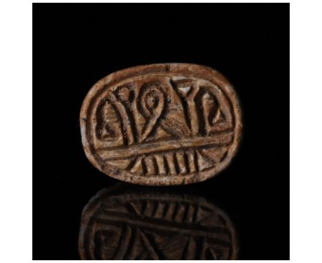 Ca. 1st Millennium BC. Ancient Egyptian. Steatite scarab with well-modelled head, perforation for suspension and hieroglyphic