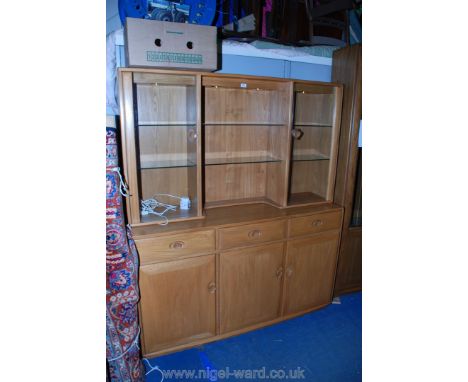 A good Ercol ''Windsor'' Dresser having plain top with central open, illuminated section with two adjustable glass shelves, f