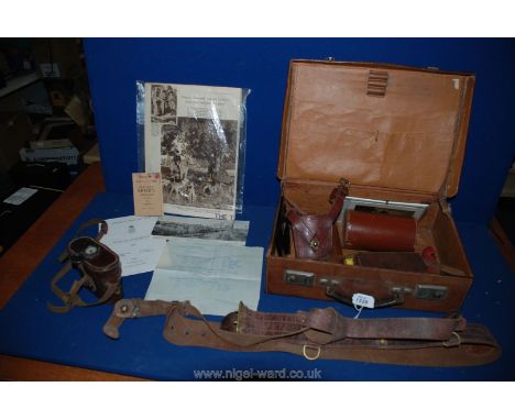 A small brown Leather Case, a pair of military Binoculars in a leather case with compass and leather uniform straps and belts