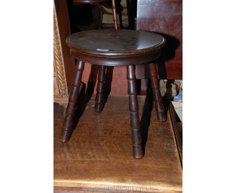 A circa 1900 Mahogany Stool with thick circular, moulded edge top and on four turned bobbin style legs.