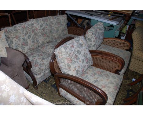 A circa 1920 Mahogany and Bergere three piece Lounge Suite comprising three seater settee and two armchairs, having moulded h