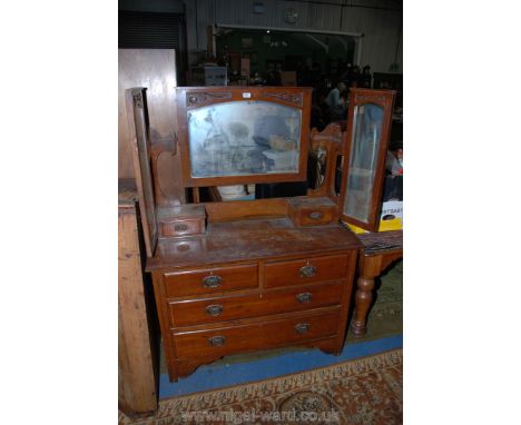 An art Nouveau Walnut Dressing Chest with central large rectangular bevel plate mirror with arch top glass flanked by two nar