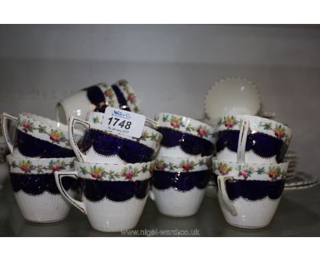 A pretty Teaset for twelve with royal blue and gilt swag style panels and floral rim, comprising twelve cups, saucers and tea