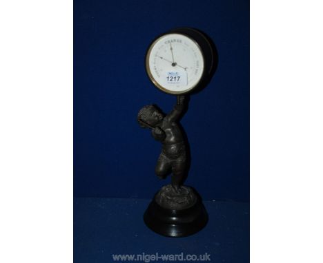 A late 19th c. Spelter figure table top Barometer, the circular aneroid barometer in the form of a drum being elevated and be