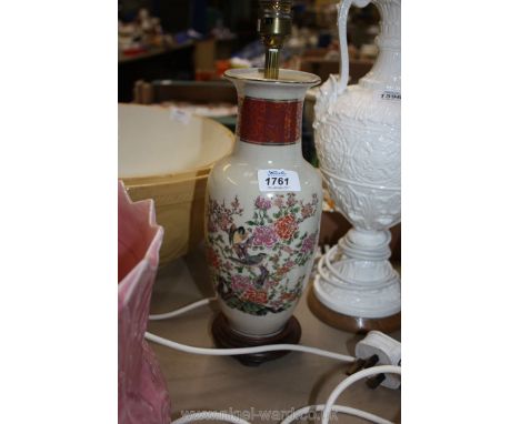 A china Table lamp decorated with birds sitting in a Prunus tree, on wooden base.