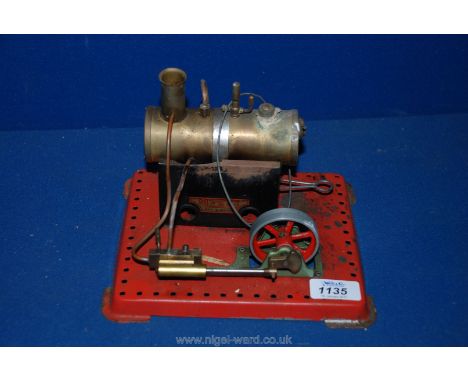 A Mamod model Static Steam Engine with fire box, pressure valve, whistle and free standing piston and flywheel and all on a r