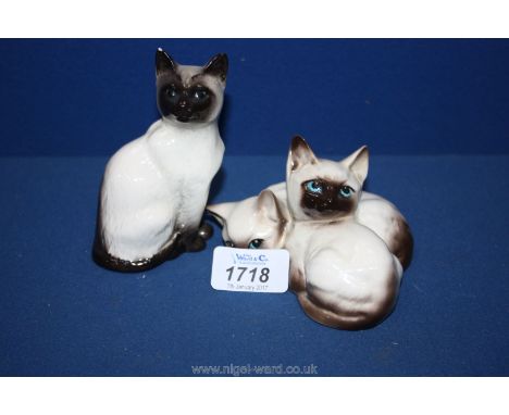 A Beswick model of two Siamese Kittens and a seated Siamese cat (ear damaged).