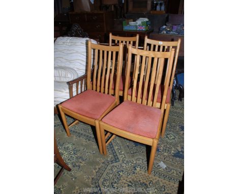 A set of four Ercol ''Windsor'' Dining Chairs in light Oak with slatted backs and terracotta fabric applied seats.