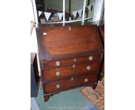 A good Georgian Mahogany Bureau, the plain top over the cleated edge fall with moulded edge and brass escutcheon opening onto