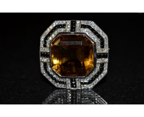 ****A citrine, diamond and black stone octagonal brooch, central orange citrine surround by a multi layered frame encrusted t