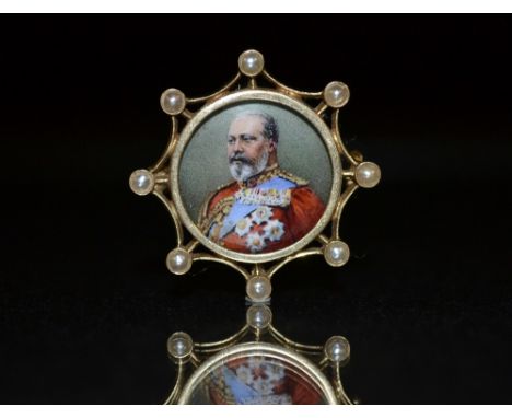 A George VII enamel portrait brooch, painted in full regalia, surrounded by an open eight point frame, each point inset with 