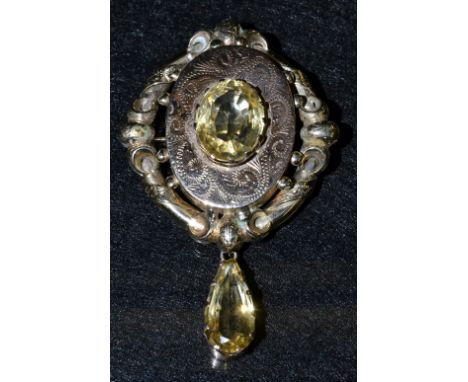 A Victorian citrine and yellow metal mourning brooch, central oval citrine crown claw, rose metal floral panel, within an ope