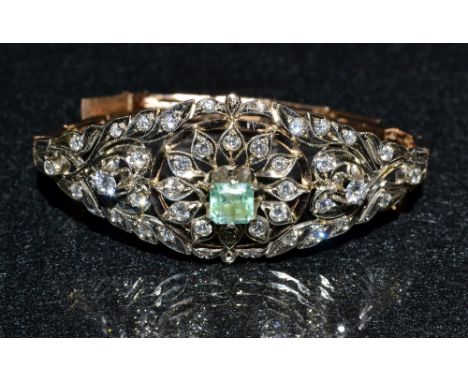 An early 20th century Russian emerald and diamond open work bracelet, central rectangular baguette emerald approx 0.60ct, wit