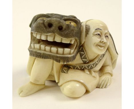 Vintage Japanese Carved Ivory Netsuke, Man with Fu Dog Mask. Signed. Good condition. Measures 1-1/2 inches tall and 2-3/8 inc