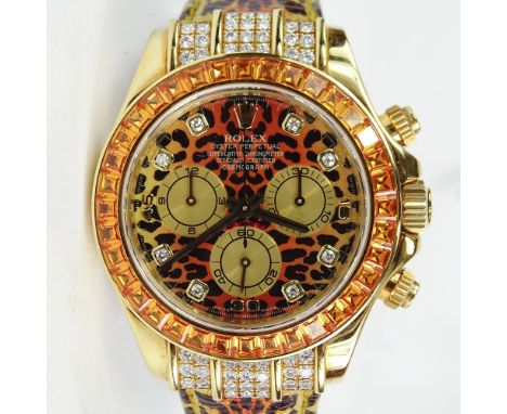 Men's Rolex 18 Karat Yellow Gold Daytona Leopard Watch with Diamond and Orange Sapphire Bezel and with Box and Papers. Slight