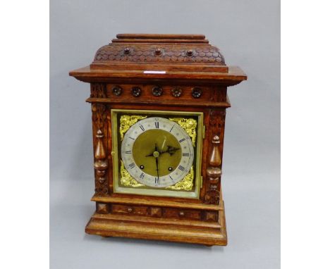 Oak cased mantle clock, the brass dial with a silver chapter ring with Roman numerals and Cherub spandrels, 43cm high 